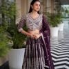 Mid-length photo of a woman wearing a purple Sider Lehenga with a scalloped hemline on the blouse and silver jewelry.