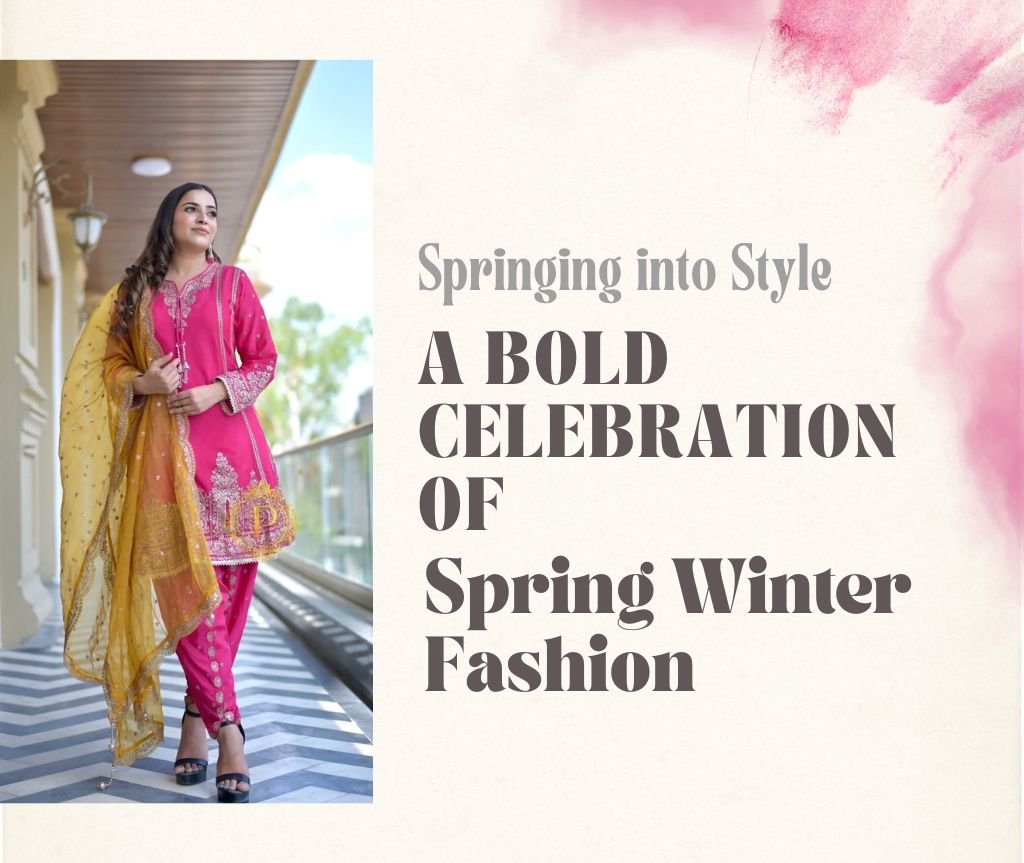 A woman wearing a bright pink embroidered ethnic outfit with a mustard-yellow dupatta, standing on a balcony corridor, showcasing a Spring-Winter fashion look.